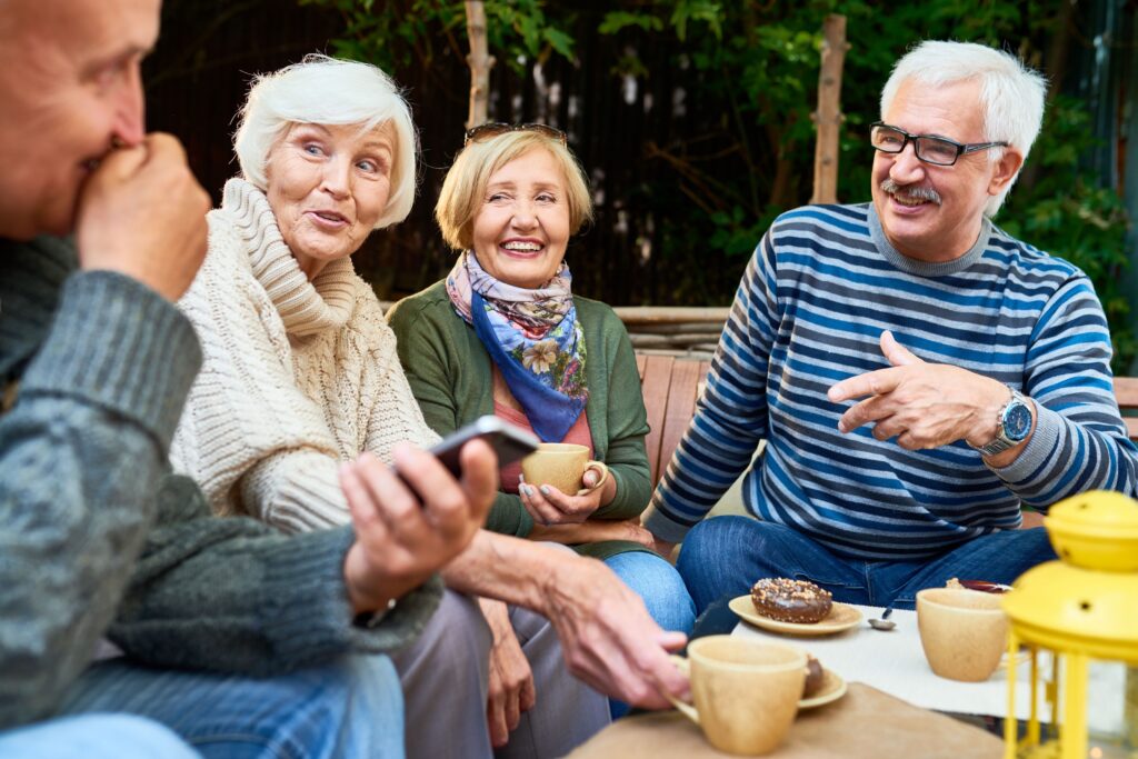 A group of seniors talking over coffee and donuts